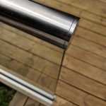 aluminox Slotted end cap on slotted handrail installed ontop a glass balustrade on decking